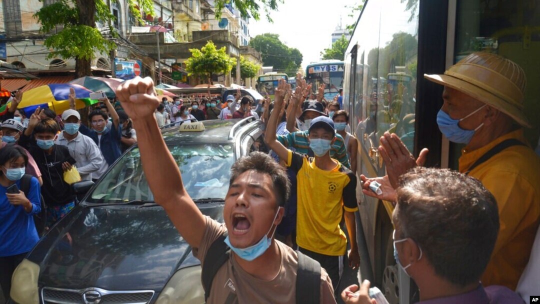 FILE - Anti-coup protesters shout slogans during a demonstration, May 6, 2021, in Yangon, Myanmar.