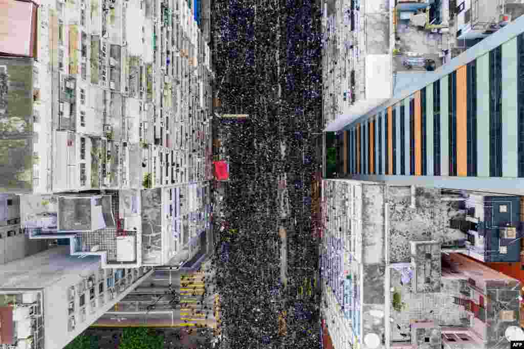 Thousands of protesters march through the street in a new rally against a controversial extradition law proposal in Hong Kong.