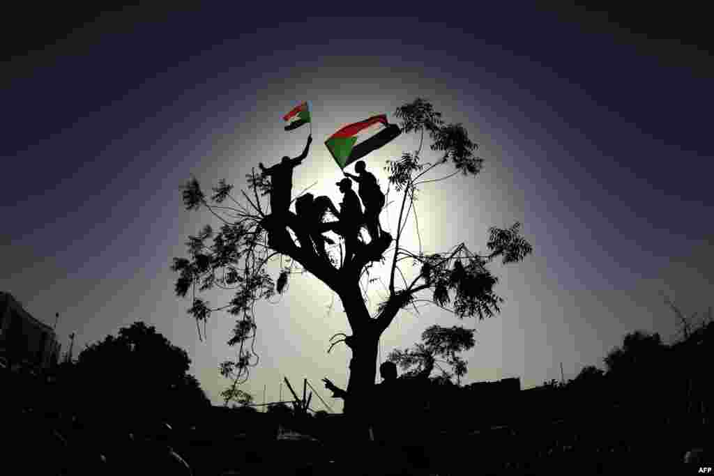 Sudanese protesters wave the national flag during a "million-strong" march outside the army headquarters in the capital Khartoum.