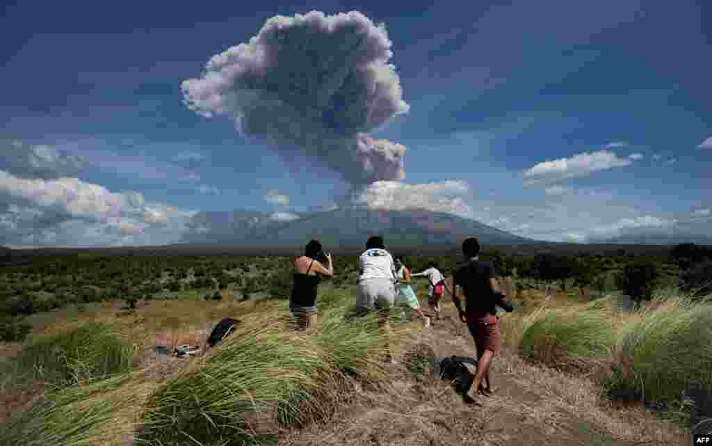 A plume of ash is released as Mount Agung volcano erupts, seen from the Kubu subdistrict in Karangasem Regency on Indonesia's resort island of Bali.