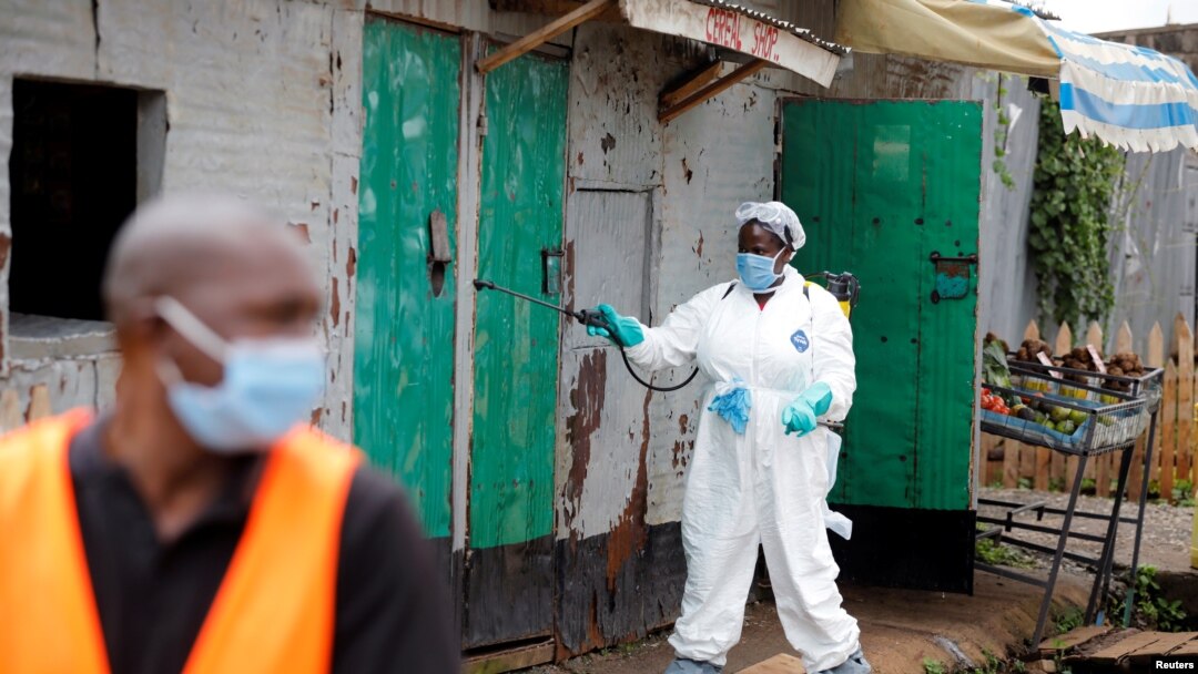 A Nairobi municipality worker sprays disinfectant in an effort to fight against the spread of the COVID-19 in the Kawangware neighborhood of Nairobi, Kenya, May 2, 2020.