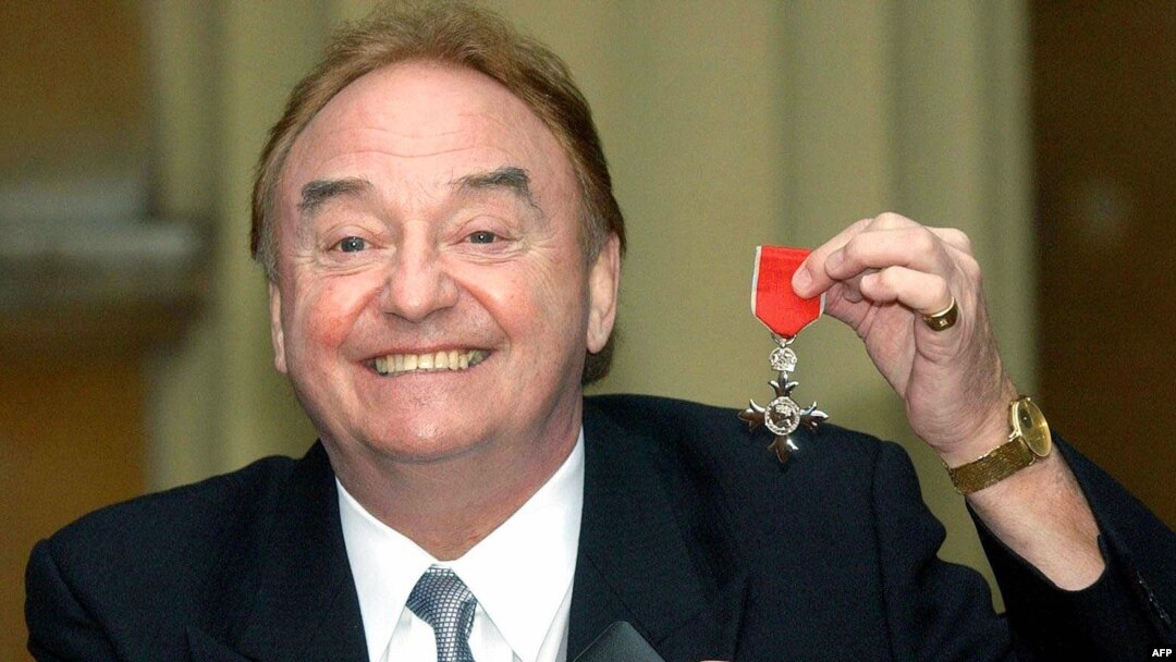 FILE - In this photo taken Dec. 12, 2003, sixties singing sensation Gerry Marsden poses with his MBE for services to Liverpudlian Charities at Buckingham Palace in London