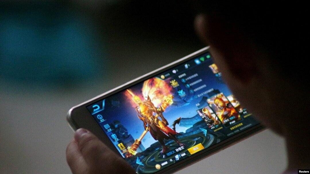 FILE - A child plays the game Honour of Kings by Tencent at home in Dezhou, Shandong province, China, July 2, 2017. 