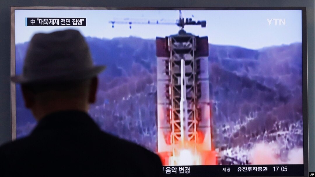 FILE - A man watches a TV news program showing a file footage of North Korea's rocket launch at Seoul Railway Station in Seoul, South Korea, April 28, 2016. South Korean media reported Thursday that North Korea may be preparing to test-launch a new, upgraded prototype of an intercontinental ballistic missile.