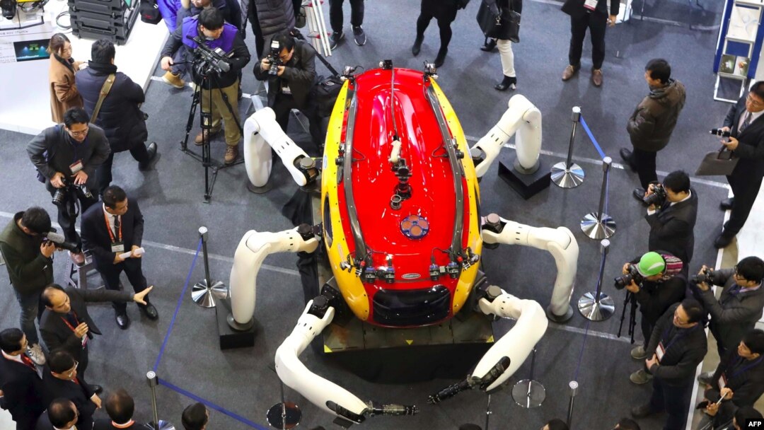 Visitors look at an undersea exploration robot during a drone show at the BEXCO Exhibition Hall in the southeastern port city of Busan on January 19, 2017.