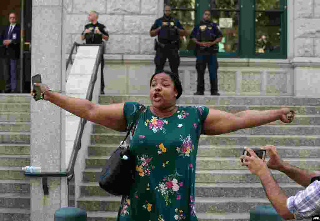 Eric Garner's daughter Emerald Snipes speaks to the press outside the Eastern District of New York. The U.S. Justice Department will not press charges against a New York policeman involved in the controversial 2014 death of a 43-year-old black man after he was put in a chokehold, his family and officials said Tuesday. Eric Garner, a father of six, was detained by New York police on July 17 that year for allegedly illegally selling cigarettes in Staten Island.
