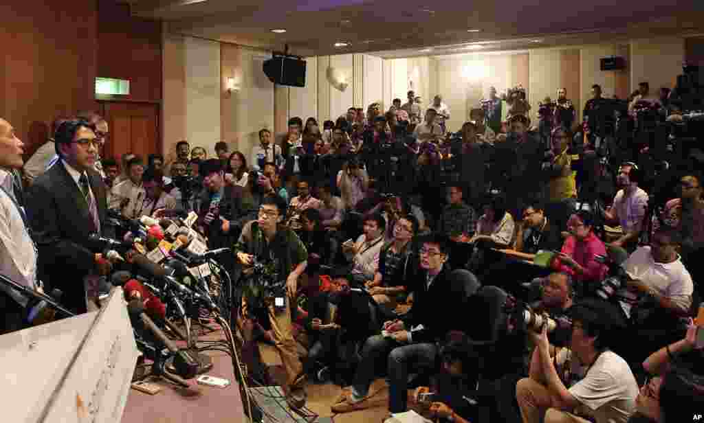 Malaysia's Department of Civil Aviation director general Azharuddin Abdul Rahman, second from left, speaks during a press conference at a hotel in Sepang, Malaysia, March 10, 2014. 