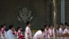  Chinese students wait outside the U.S. Embassy for their visa application interviews in Beijing, China.