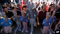 Members of the Turkey Youth Union hold effigies of U.S. President Barack Obama during a protest in Antalya, Turkey, Nov. 15, 2015. 