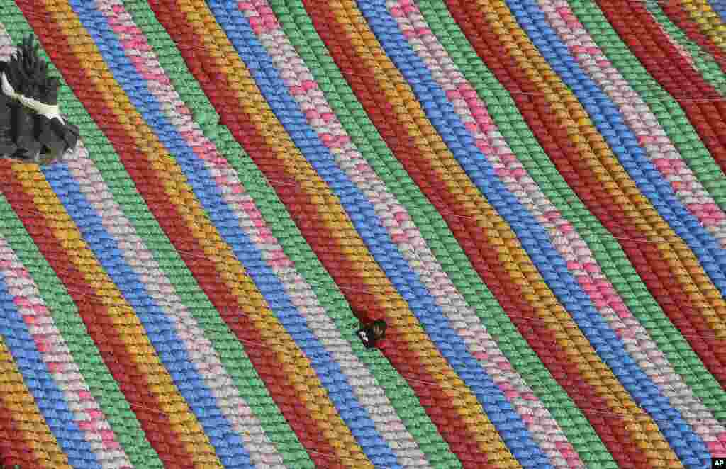 A worker adjusts lanterns for upcoming celebration of Buddha's birthday at Jogye temple in Seoul, South Korea.
