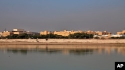 FILE - In this Friday, Jan. 3, 2020, file photo, the U.S. Embassy is seen across the Tigris River in Baghdad, Iraq. Iraq's military says two rockets hit Baghdad's heavily fortified Green Zone, the seat of the government and home to the U.S. Embassy. (AP P