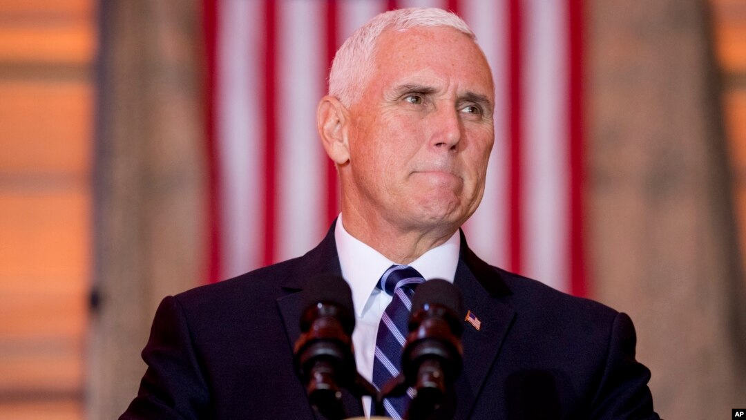 FILE - Vice President Mike Pence pauses while speaking to troops at Al Asad Air Base, Iraq, Nov. 23, 2019. 