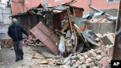A man inspects the damage caused by an earthquake in Zagreb, Croatia, March 22, 2020. A strong earthquake shook Croatia and its capital, causing widespread damage and panic. 