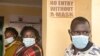 FILE - People wait to be vaccinated against COVID-19 at Ngando informal settlement in Nairobi, Kenya, Dec. 16, 2021.