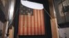 In this Nov. 20, 1998 file photo, workers at the Smithsonian's National Museum of American History cover the flag that inspired "The Star Spangled Banner," prior to the flag's restoration.
