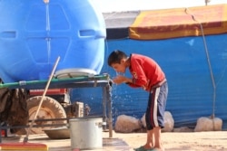 Yasser, 12, says he tries to keep clean because of the coronavirus, but it's not nearly as frightening to him as the war, in Idlib, Syria, July 24, 2020.
