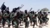 FILE - Hundreds of newly trained al-Shabab fighters perform military exercises in the Lafofe area 18 km south of Mogadishu, Somalia, Feb. 17, 2017. 