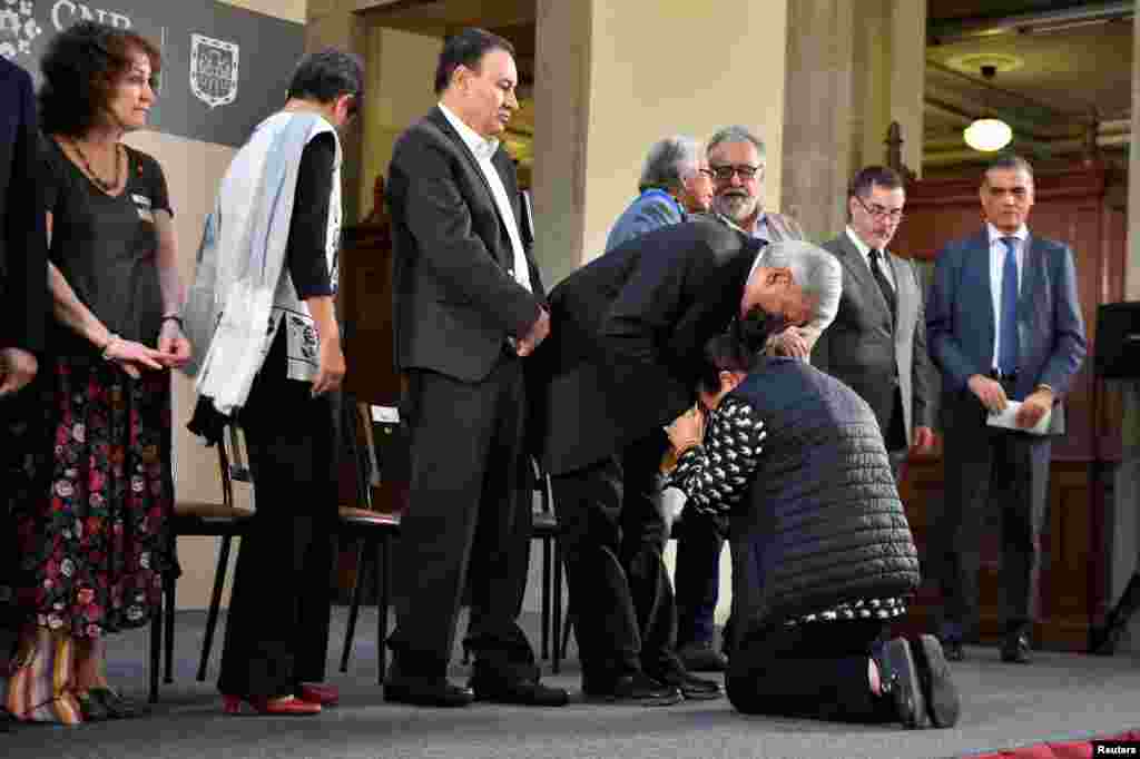 Mexico's President Andres Manuel Lopez Obrador comforts a woman to ask him for help to look for her missing relative at National Palace in Mexico City. Mexican government identified thousands of human remains that have accumulated in morgues and mass graves during more than a decade of gang violence.