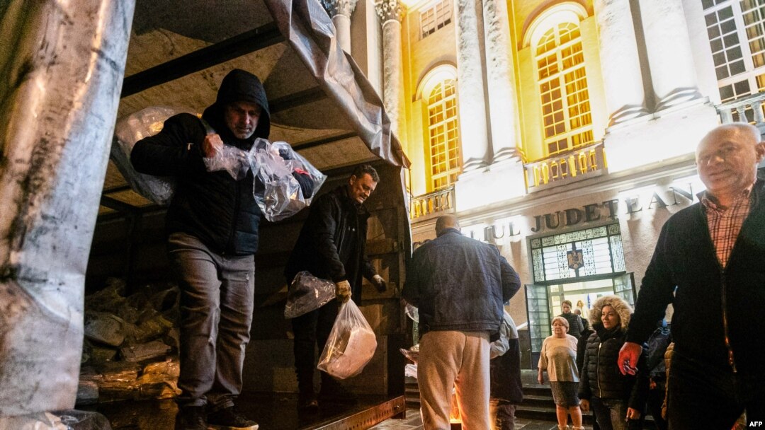 People unload bags of ballots from a truck at the Timis county Electoral Bureau in Timisoara, Romania, on Nov. 29, 2024. 