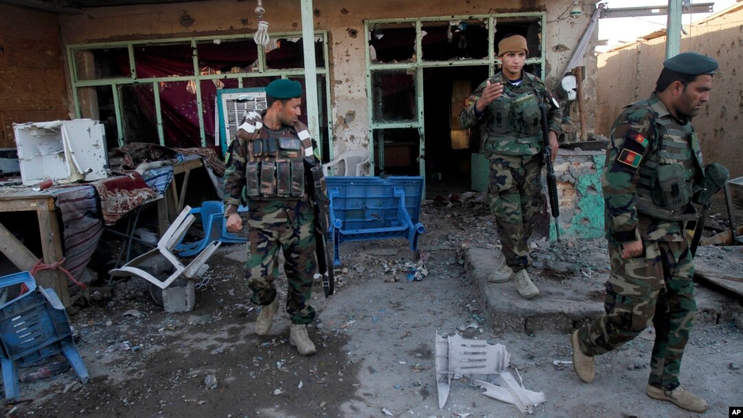 Afghan security forces assess damage after clashes between Taliban fighters and Afghan forces at Kandahar Airfield, Afghanistan, Dec. 9, 2015.
