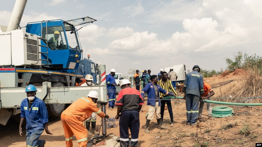 Rescue workers install a pump to drain water from a collapsed mineshaft at Ran Mine, in Bindura, Zimbabwe, Nov. 26, 2020.