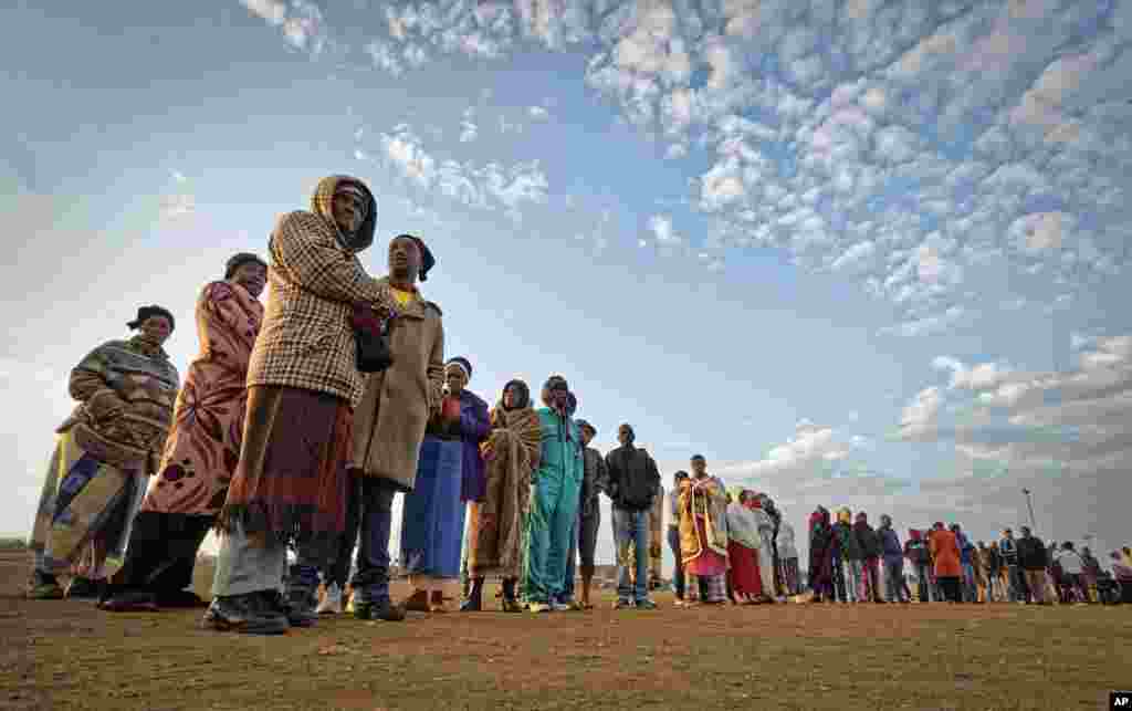 South Africans queue in the early cold morning to cast their votes in the mining settlement of Bekkersdal, west of Johannesburg.