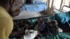 FILE - A medic takes care of a malnourished child with malaria in a hospital in Bor, South Sudan, March 15, 2014. 
