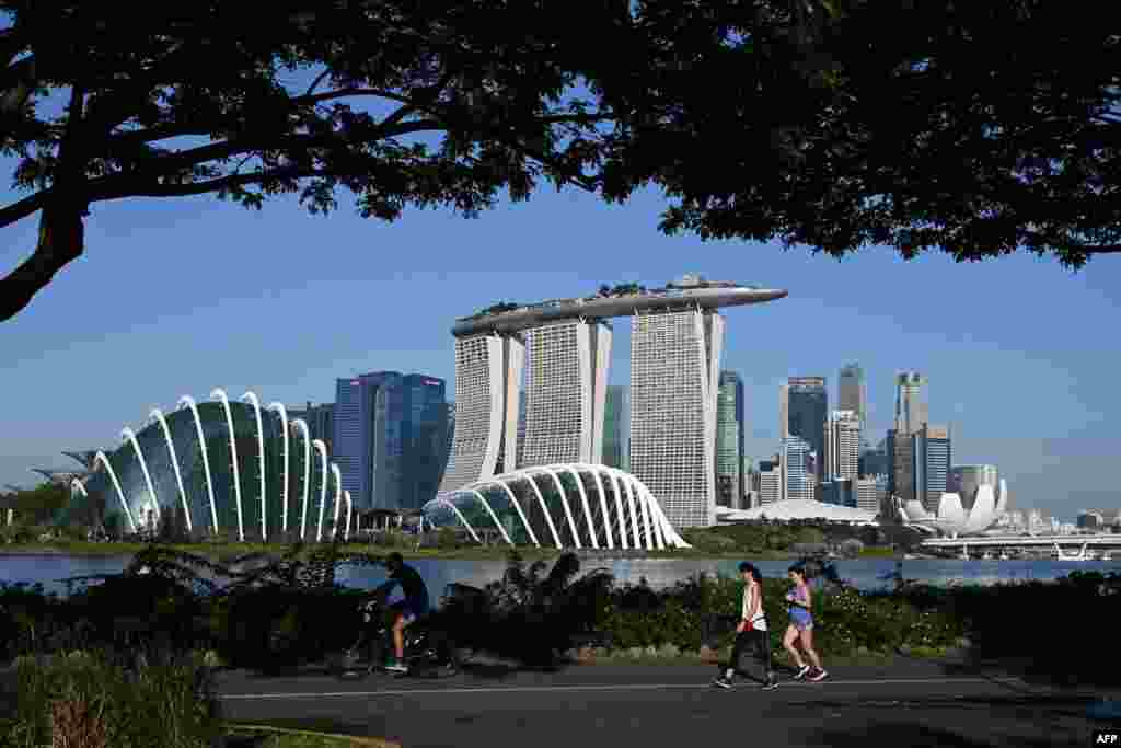 People make their way along the park at Marina Bay East as they enjoy the holiday to mark the country's National Day holiday in Singapore.