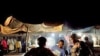 Women purchase grilled chicken from a street vendor in the main Konyo Konyo market in the Juba, South Sudan, July 2011. (file photo)