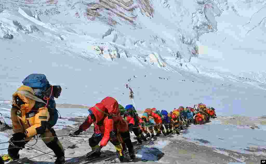 A long queue of mountain climbers line a path on Mount Everest just below camp four, in Nepal. Seasoned mountaineers say the government's failure to limit the number of climbers on Mount Everest has resulted in dangerous overcrowding and a greater number of deaths.