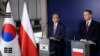 South Korean Minister of Foreign Affairs Cho Tae-yul, left, and Poland's Foreign Minister Radek Sikorski give a statement following a meeting at the Foreign Ministry in Warsaw, Poland, March 5, 2025.