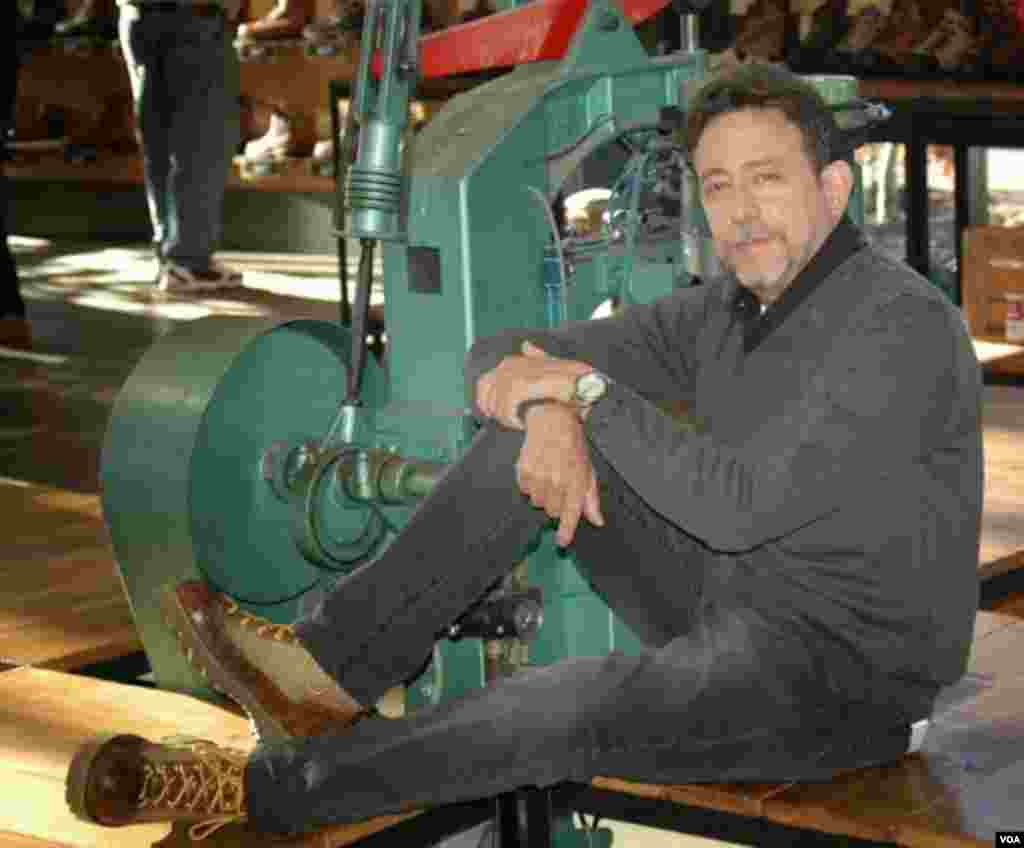 Steve Herman trying on for the first time his newly recrafted old boots at the Danner factory, Portland, Oregon, Jan. 20, 2014. (Steve Herman/VOA)