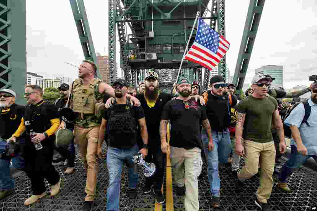 Members of the Proud Boys and other right-wing demonstrators march across the Hawthorne Bridge during an "End Domestic Terrorism" rally in Portland, Oregon, USA, Aug. 17, 2019.