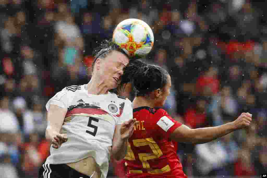 Germany's Marina Hegering, left, goes for a header with Spain's Nahikari Garcia during the Women's World Cup Group B soccer match between Spain and Germany at Stade du Hainau in Valenciennes, France.
