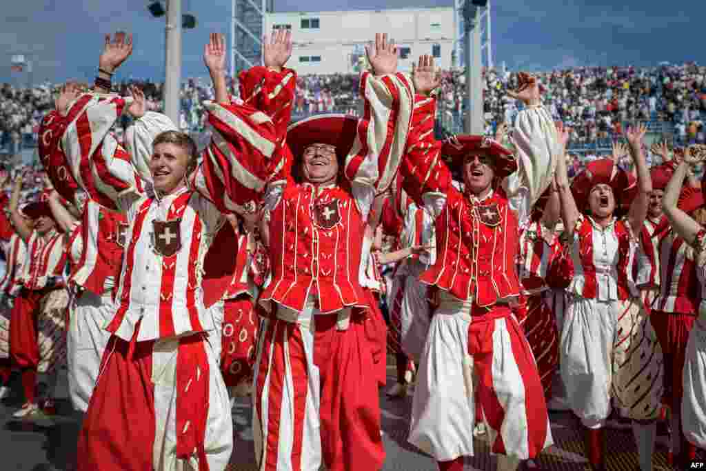 Performers react during celebrations of the Swiss National Day at the Fete des Vignerons (Winegrowers' Festival), a traditional festival which takes place approximately every 25 years in Vevey, western Switzerland.
