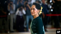 FILE - In this March 15, 2016 file photo, National League for Democracy party (NLD) leader Aung San Suu Kyi arrives in Manama's parliament in Naypyitaw, Myanmar.