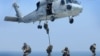 FILE - Navy SEALs training. SEALs are maritime special operations forces who strike from the sea, air and land.