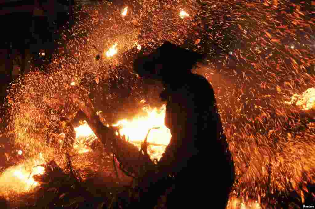 A participant is seen during the torch war or "Perang Obor," a tradition held by locals to show gratitude to God for fortune, health, and salvation, in Jepara, Central Java province, Aug. 5, 2019 in this photo taken by Antara Foto.