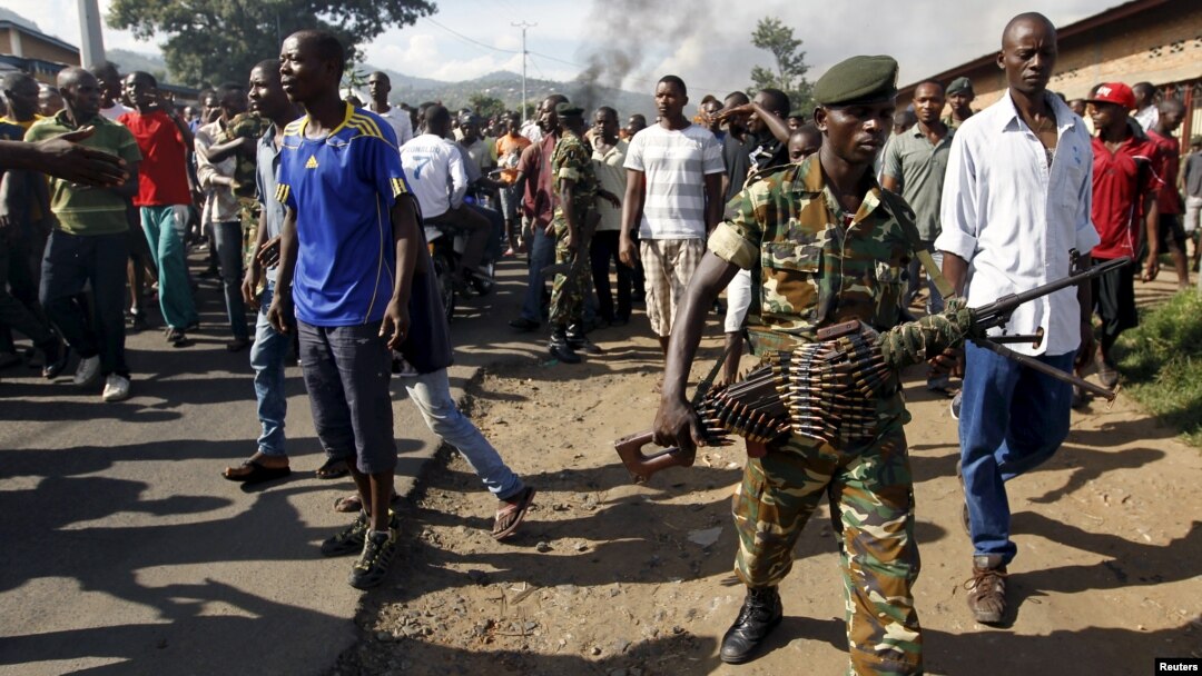 A soldier walks away from protesters in Burundi's capital, Bujumbura, as they clash with riot police. Monday was the second day of demonstrations against the president's decision to run for a third term, a move critics say violates the constitution.