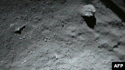 FILE - A handout photo released on November 13, 2014, by the European Space Agency, and taken by the Rosetta Lander Imaging System instrument, shows the surface of comet 67P/Churyumov-Gerasimenko during Philae's descent, from about 40 meters up.