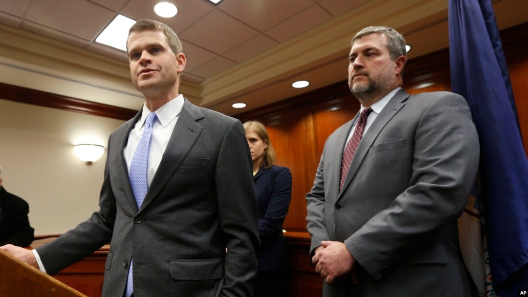 U.S. Attorney Thomas Cullen, left, speaks to the media along with FBI agent James Dwyer, right, after a plea agreement with James Alex Fields, who was charged with 30 counts stemming from a car attack in 2017, in Charlottesville, Va., March 27, 2019.