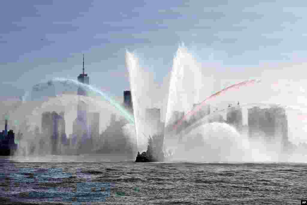 The Fire Department of New York "Firefighter II" sprays water while participating in Fleet Week New York, in New York harbor.