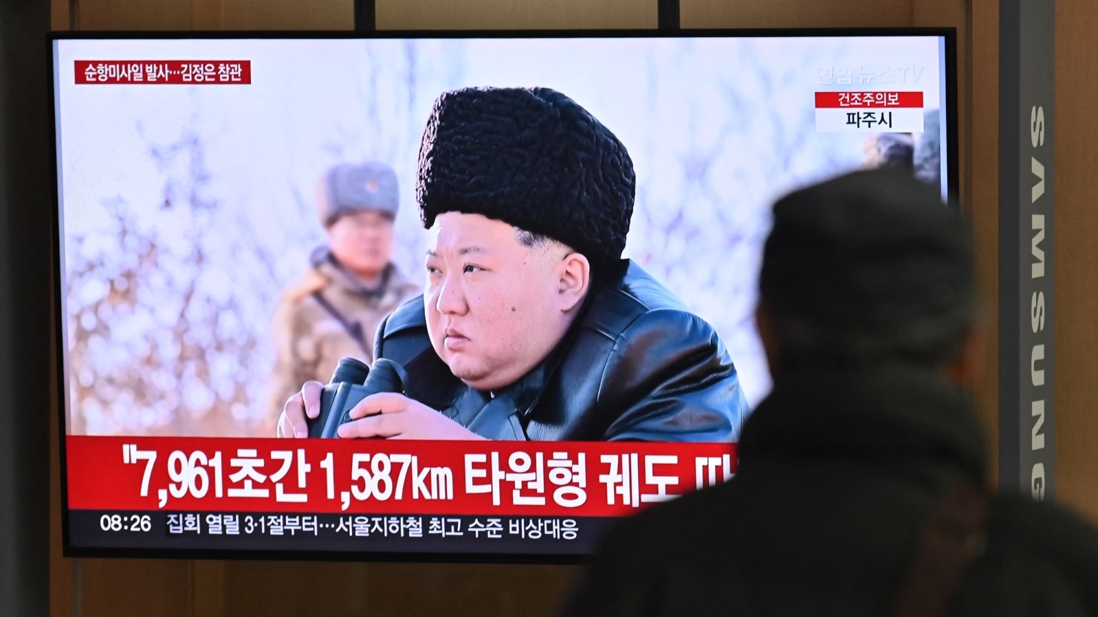 A man watches a television screen showing news footage of North Korea's leader Kim Jong Un observing a test-launch of strategic cruise missiles, at a train station in Seoul, South Korea, on Feb. 28, 2025. 