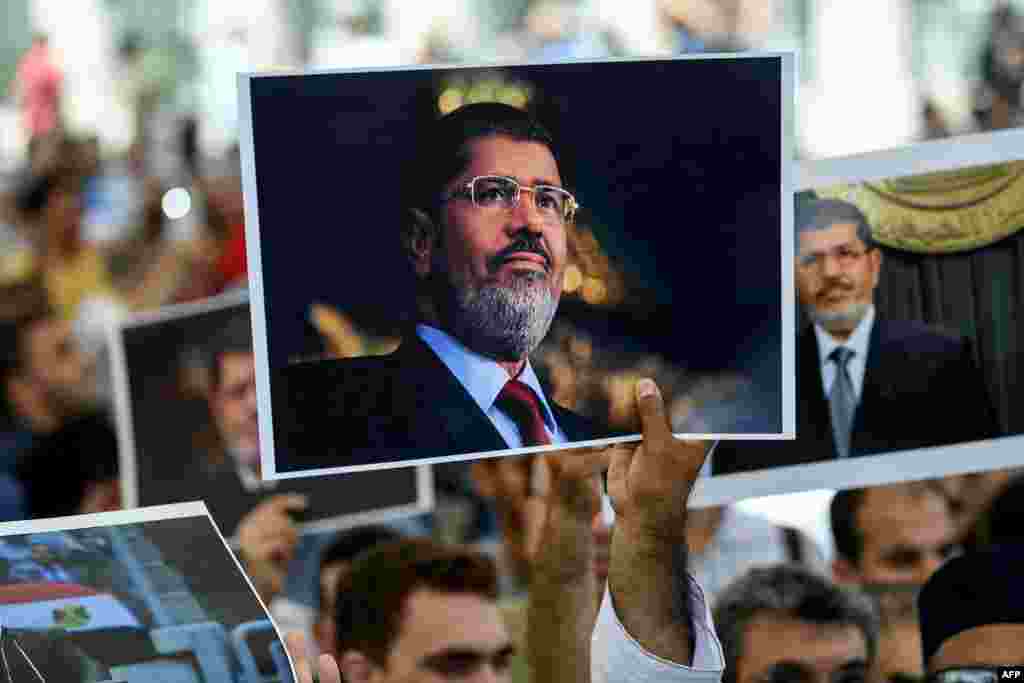 People join in prayer during a symbolic funeral ceremony for former Egyptian President Mohamed Morsi at the Fatih mosque in Istanbul, Turkey. Moris died the previous day after collapsing during a trial hearing in a Cairo court.