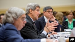 Secretary of State John Kerry, center, flanked by Treasury Secretary Jacob Lew, right, and Energy Secretary Ernest Moniz, testifies on Capitol Hill in Washington, Tuesday, July 28, 2015.