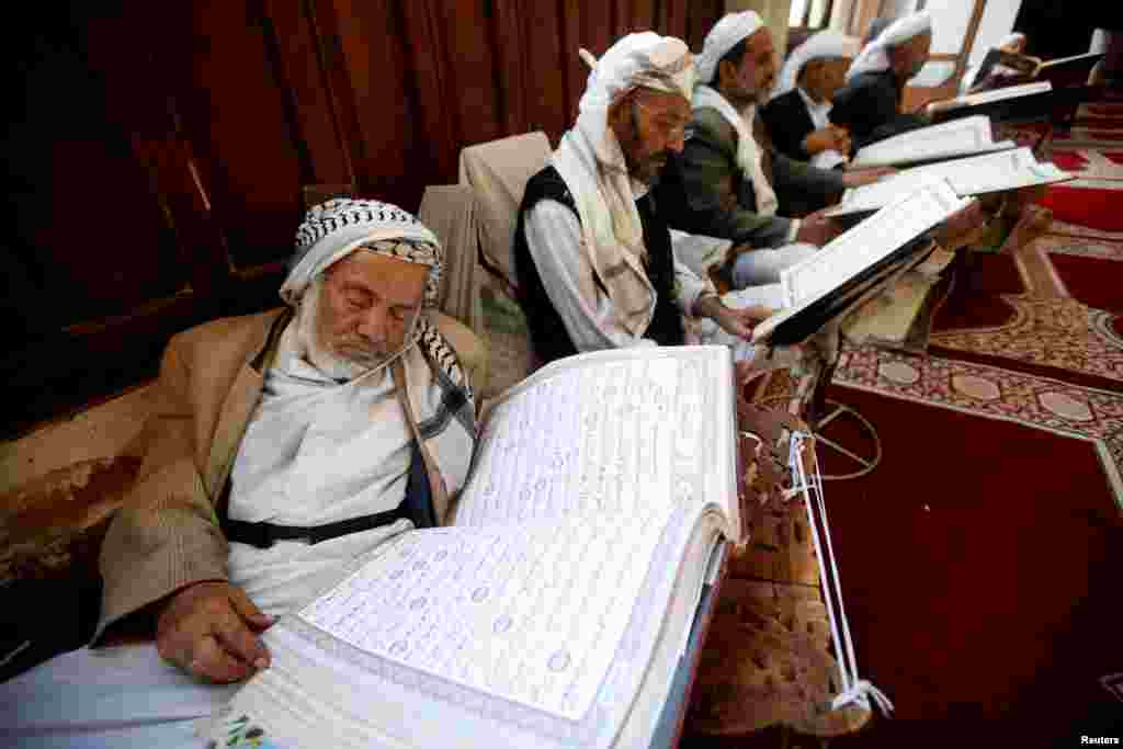 A man rests while reading the Koran at the Grand Mosque, during the holy month of Ramadan in Sana'a, Yemen.