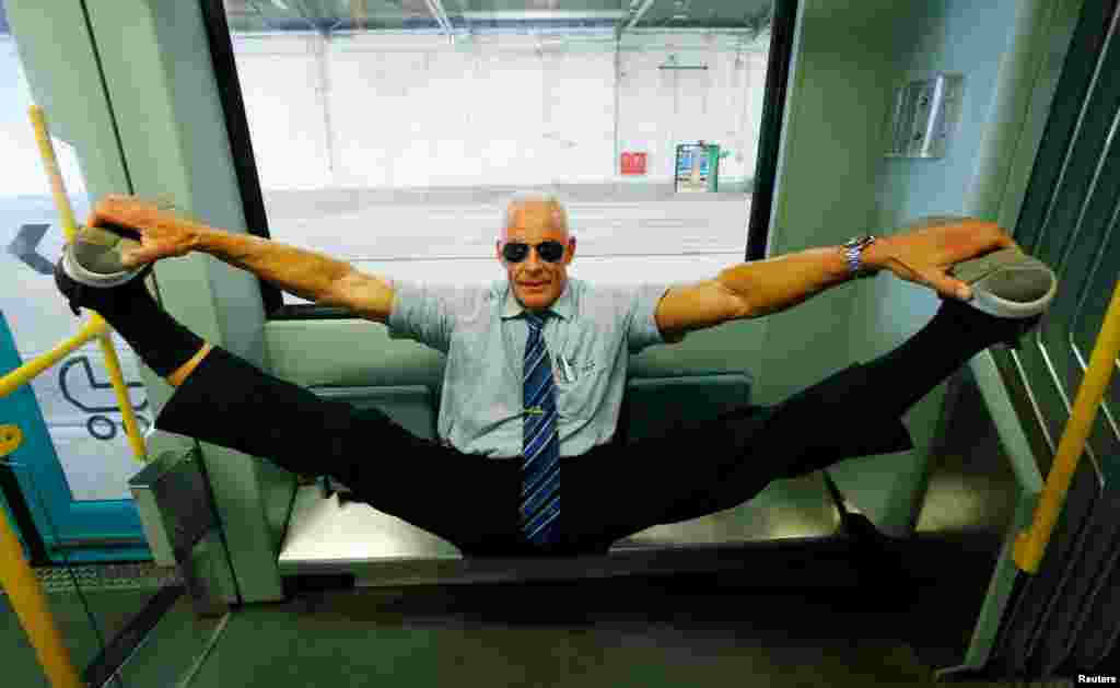 Bodybuilding tram driver Peter Wirth, alias 'Bahnbabo' practices gymnastics in a tram in Frankfurt, Germany, Aug. 1, 2019.