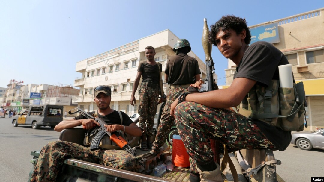 FILE - Houthi rebels patrol a street where pro-Houthi protesters demonstrated against the Saudi-led coalition in Hodeidah, Yemen.