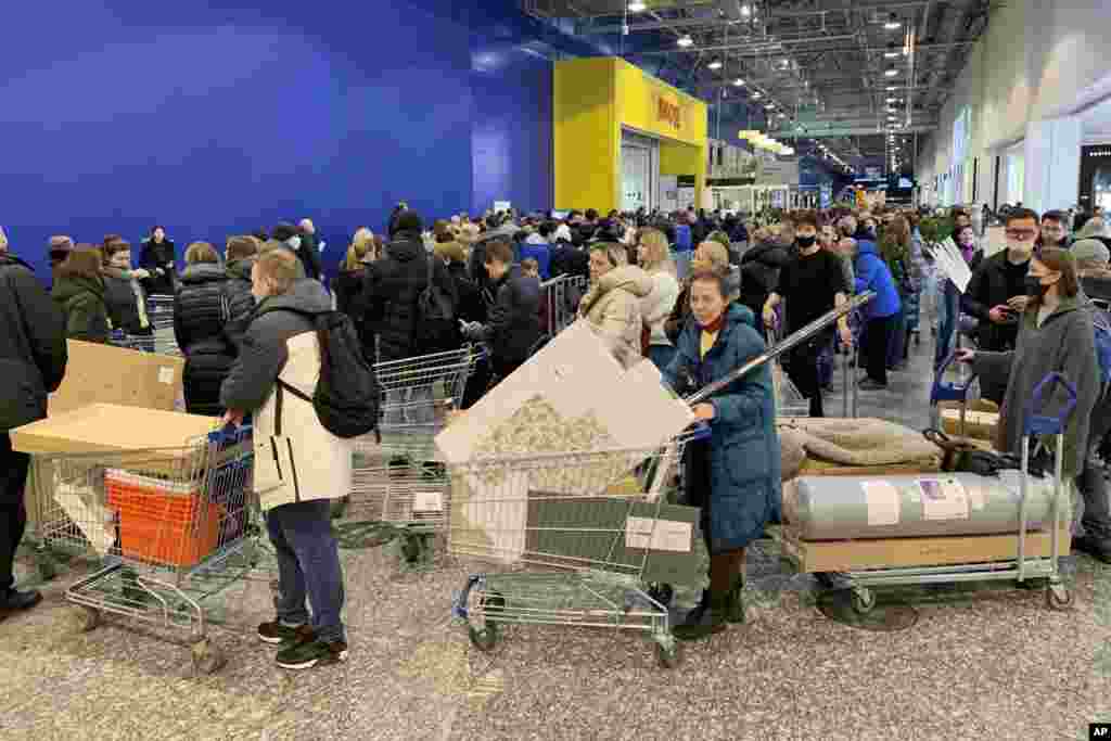People wait in long lines to pay for their purchases at the IKEA store on the outskirts of Moscow, Russia. IKEA is closing its stores and pausing all sourcing in Russia and Belarus from Friday, March 4.