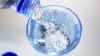 FILE - A glass is filled in with drinking water. 
